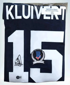 Detail showing the name KLUIVERT, No. 15, and a signature on the Ajax soccer jersey.