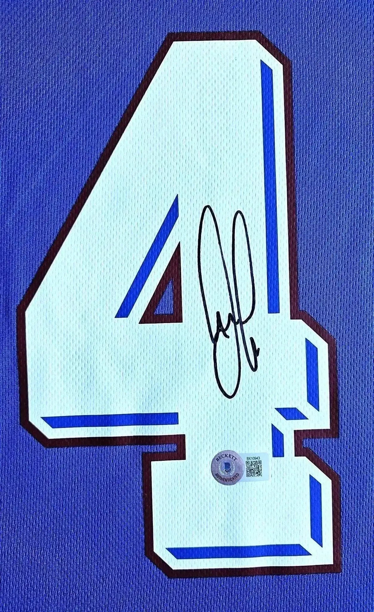 Detail view showcasing No. 4 and signature on Patrick Vieira's signed soccer jersey.