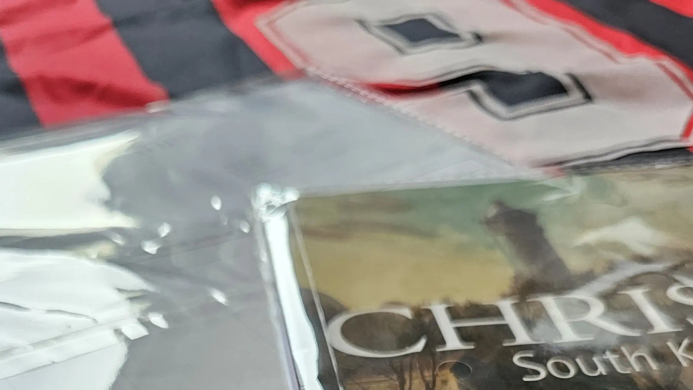 Close-up of a Christie's booklet with a document, on a red and black AC Milan football shirt with white nr. "9".