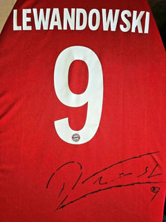 Back view showing Lewandowski, No. 9, and signature on a red soccer jersey.