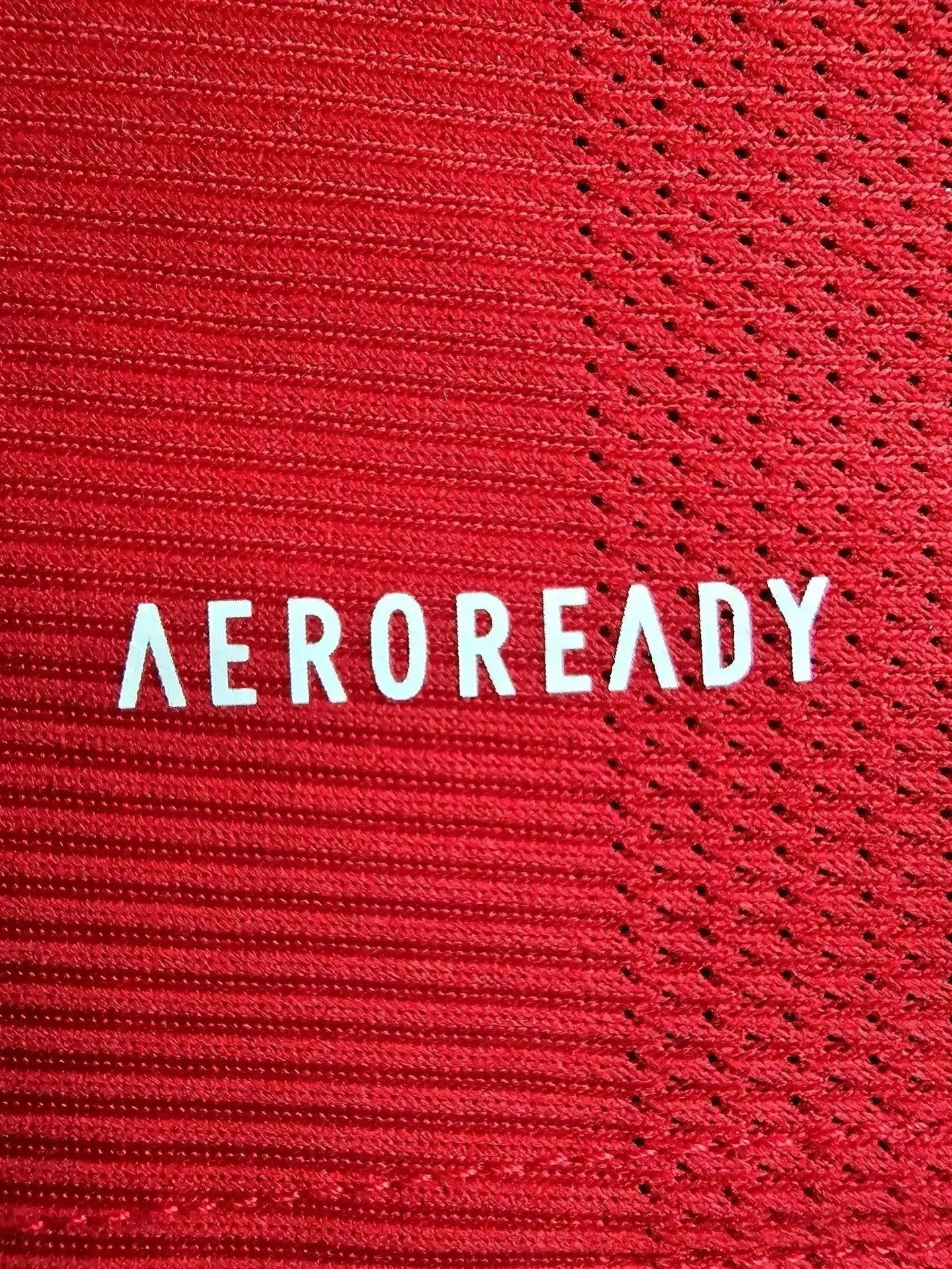 Close-up of the red fabric featuring the word 'AEROREADY' in white text.
