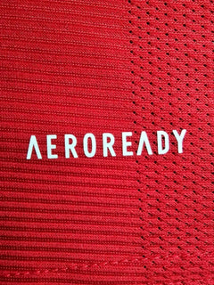 Close-up of the red fabric featuring the word 'AEROREADY' in white text.