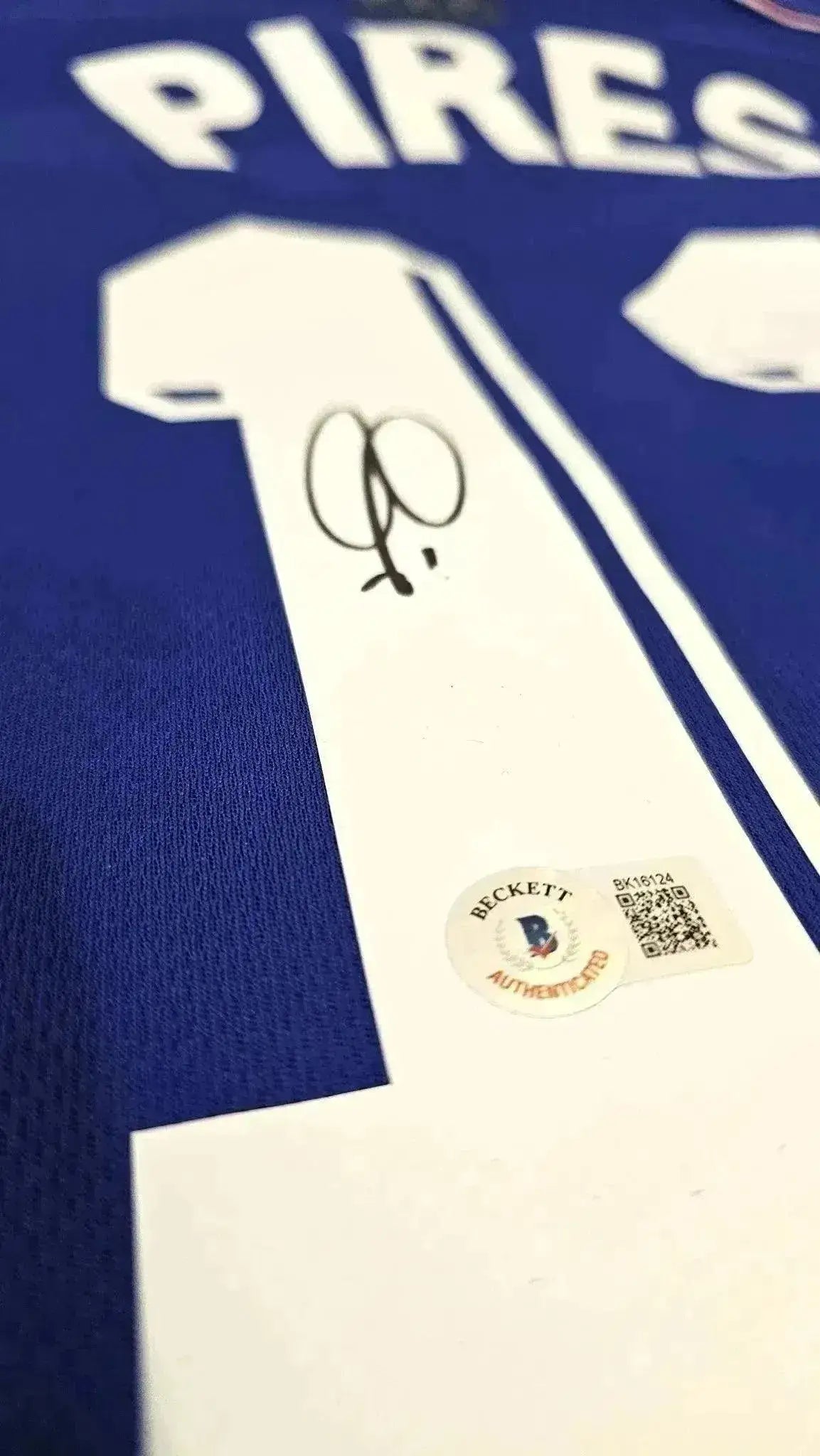 Detail view showing signature of Pires on the back of the signed soccer jersey, with Beckett COA sticker.