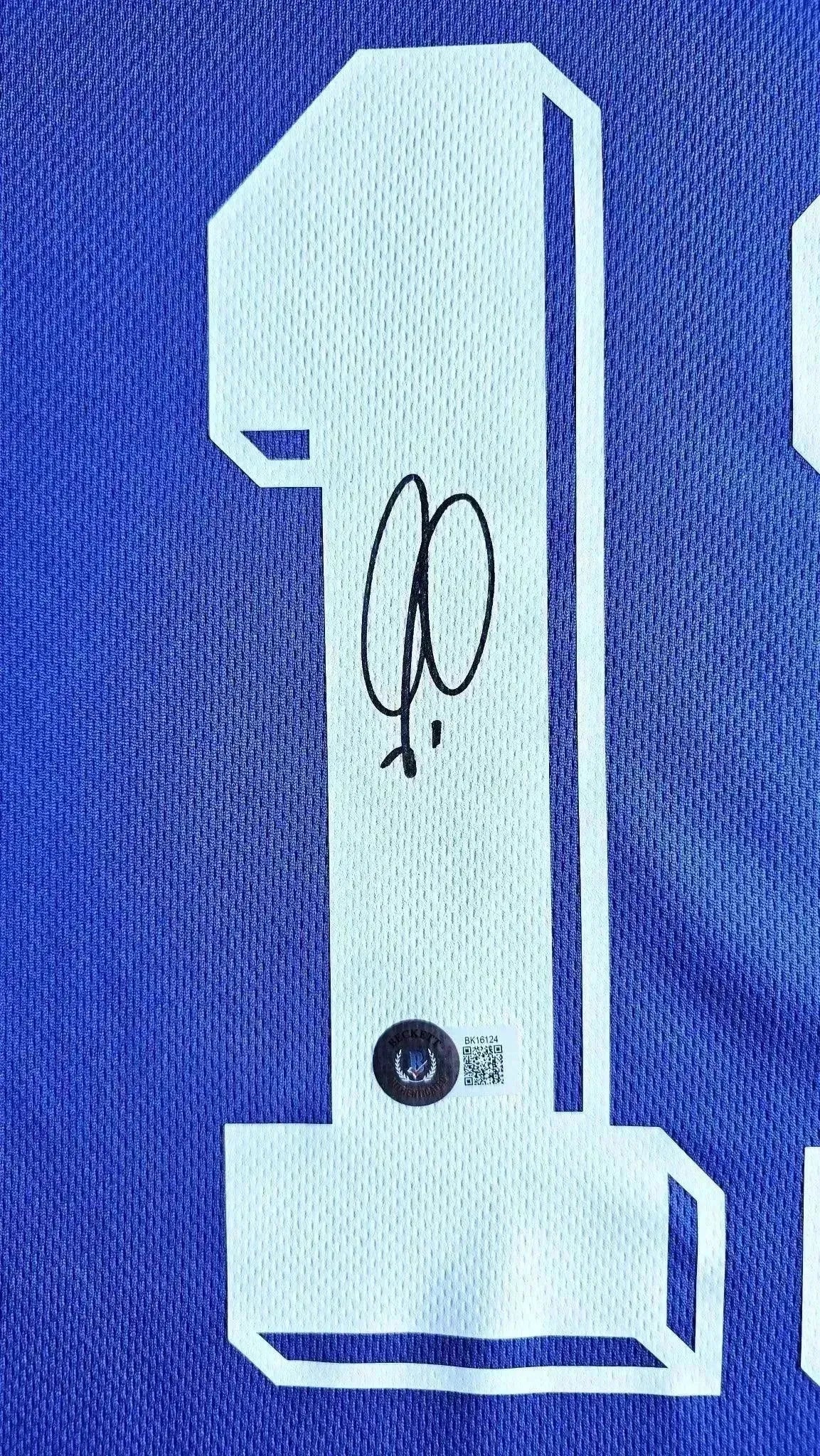 Detail view featuring signature and No. 7 on Robert Pires' France 1998 World Cup soccer jersey.