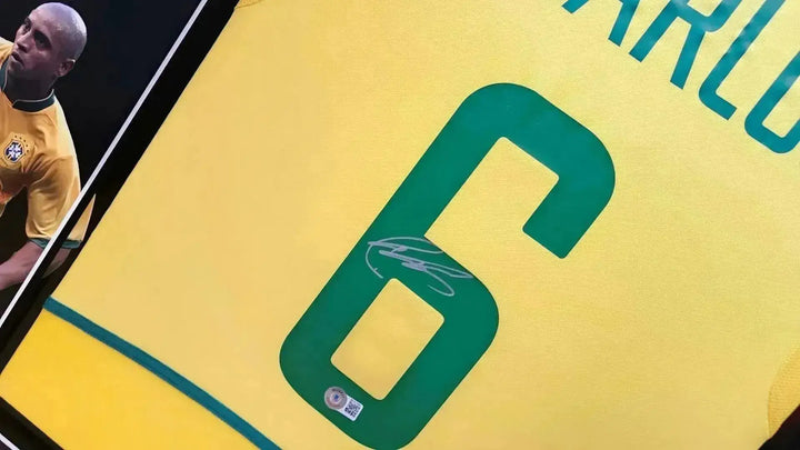 Details showing No. 6 with signature on Brazil 2002 World Cup soccer jersey.