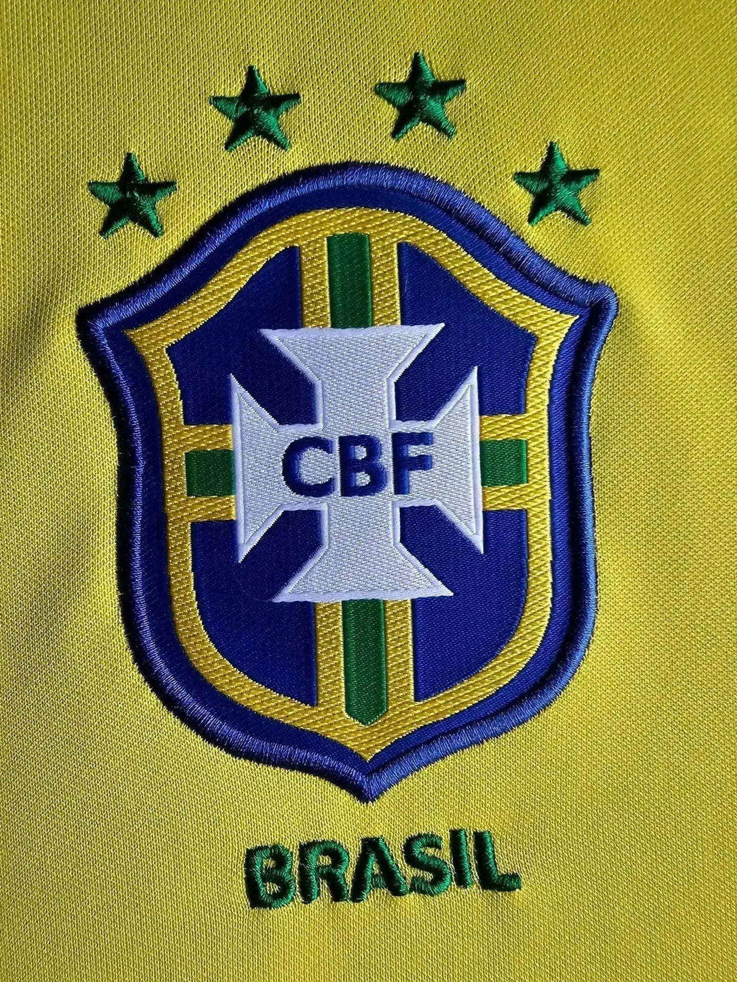 Detail view of the Brazil crest with five stars and 'BRASIL' text beneath.