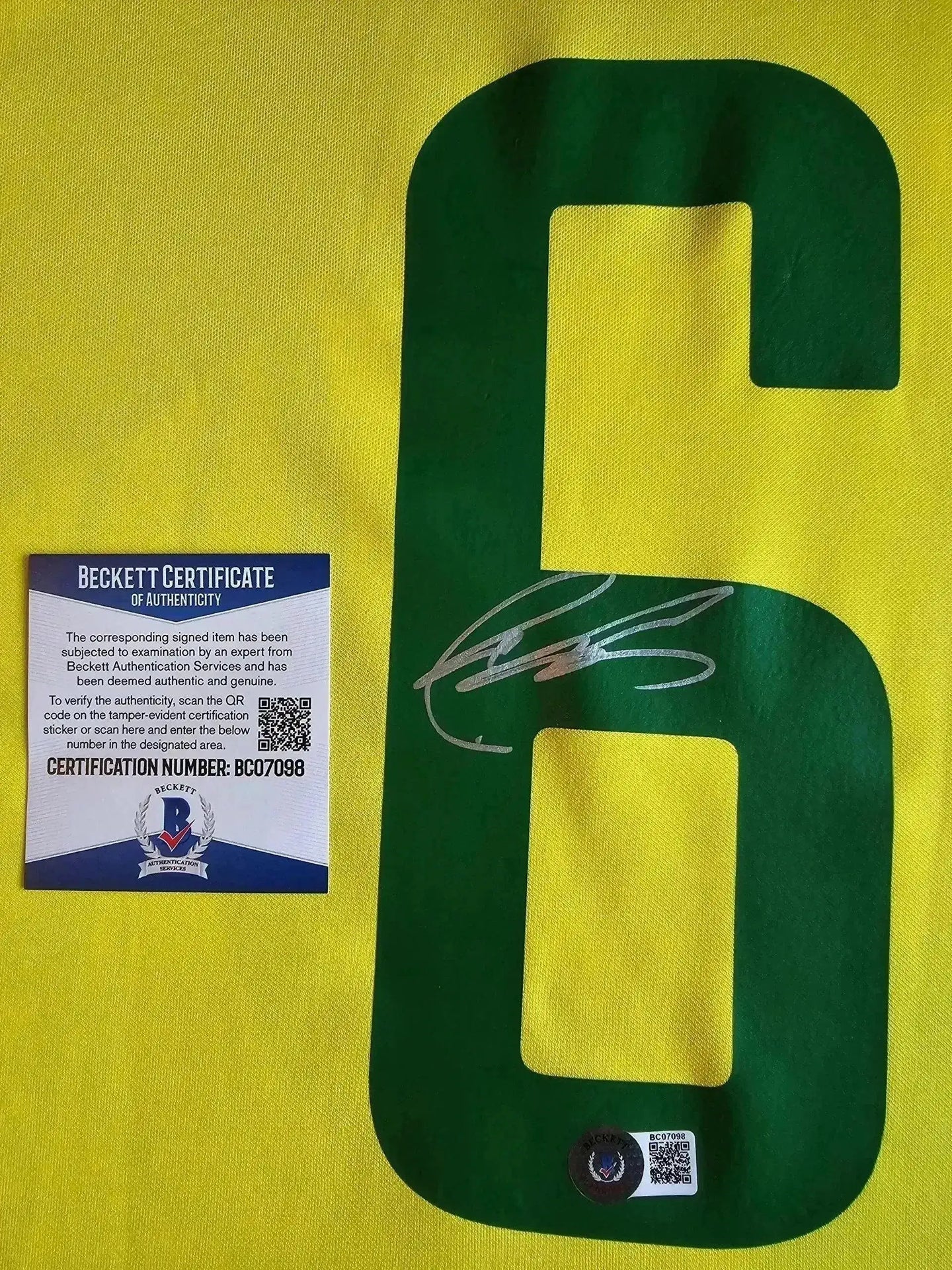 Detail view of the No. 6 on a Brazil soccer jersey featuring Roberto Carlos' signature and Beckett certificate.
