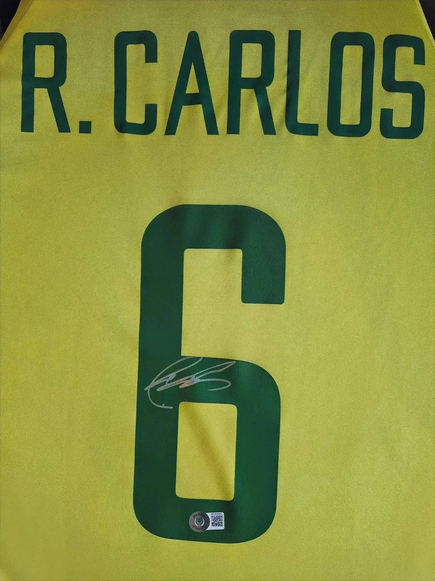 Back view showing R. CARLOS, No. 6, and the player's signature.