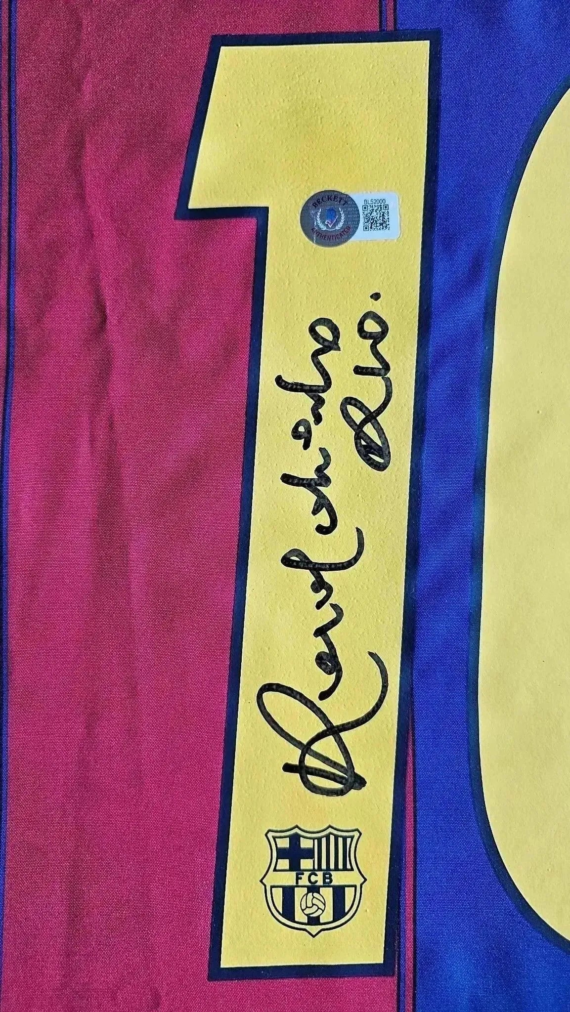Close-up of the No. 10 with Ronaldinho's signature and FC Barcelona crest detail.