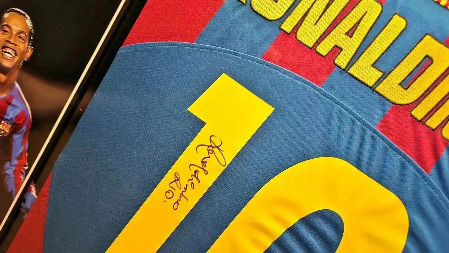 Detail showing the signature of Ronaldinho on the No. 10 FC Barcelona soccer jersey.