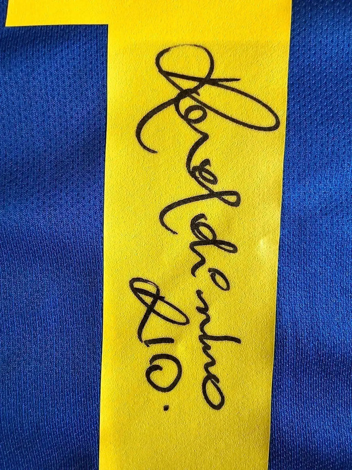 Detail showing the signature of Ronaldinho on a yellow patch with No. 10.