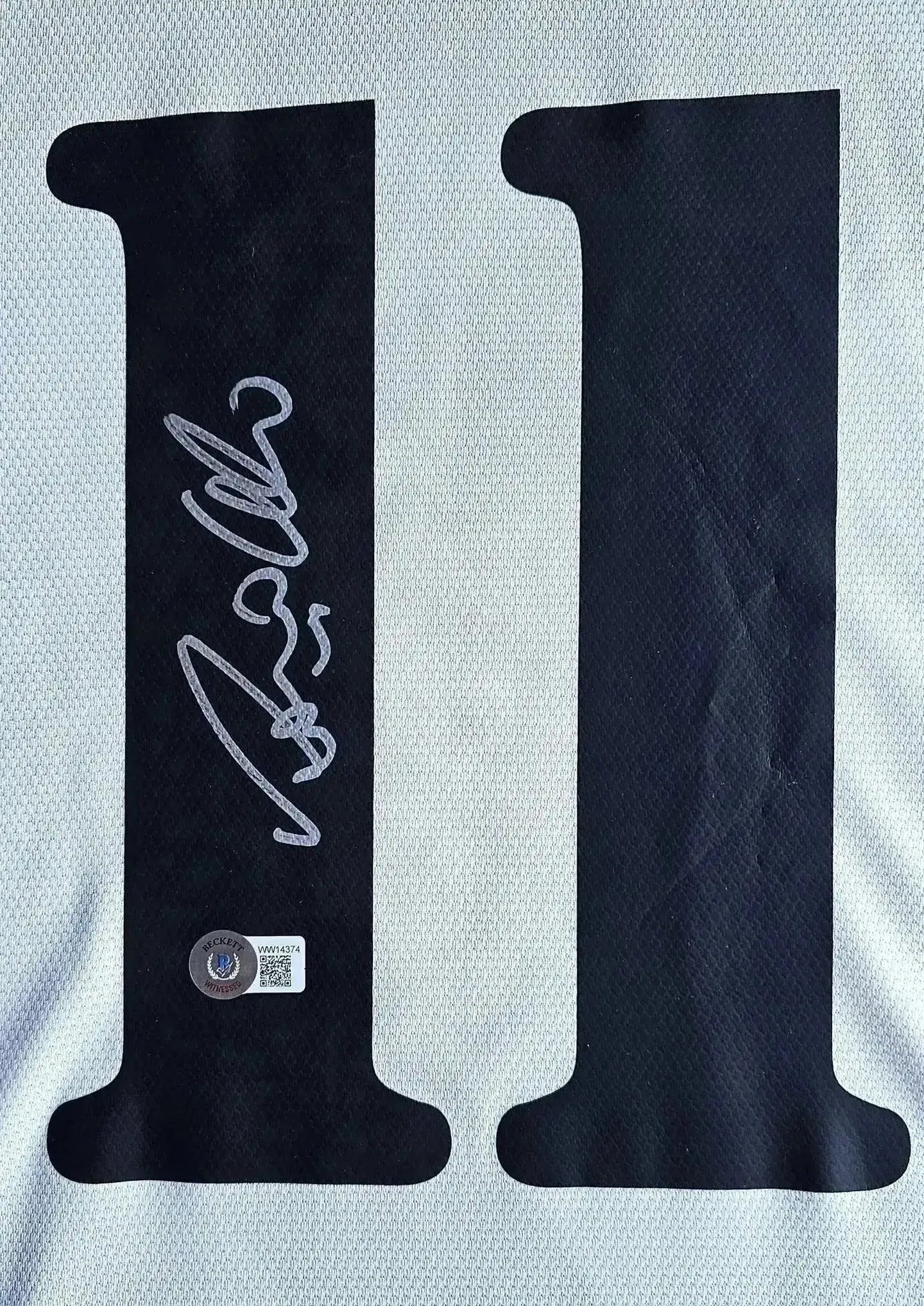 Signature of Ronaldo Lima on the No. 11 of the Real Madrid soccer jersey.