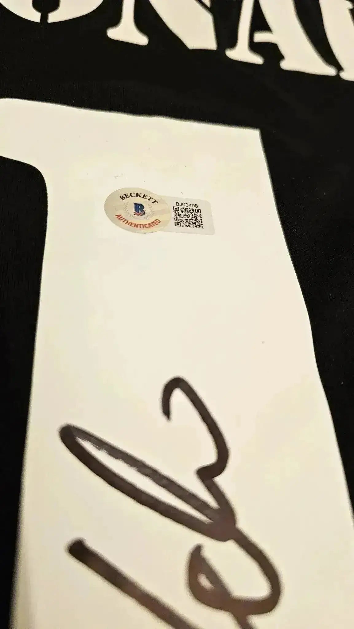 Close-up of signature detail with Beckett authentication sticker on Ronaldo Nazário soccer jersey.
