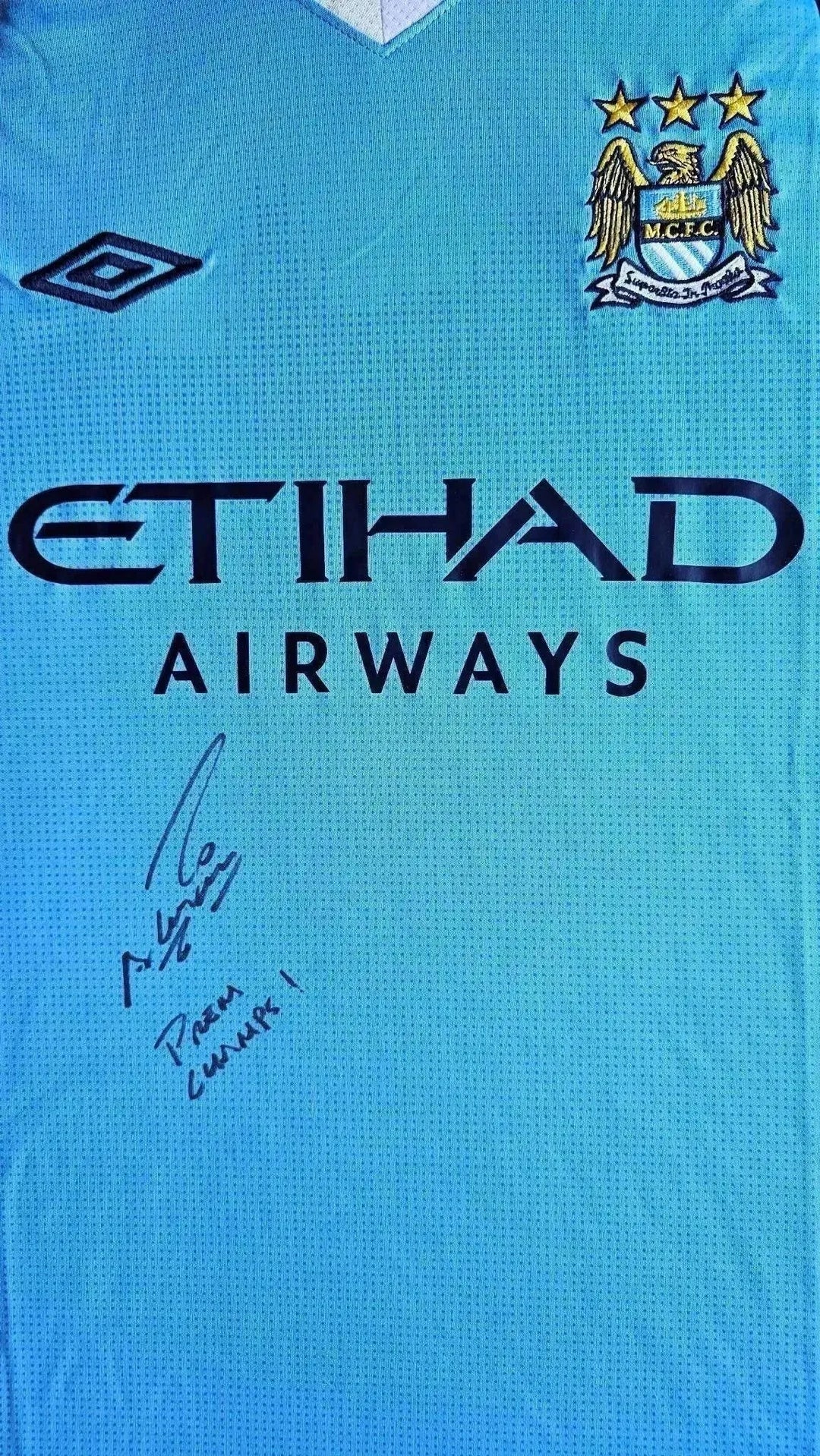 Front view showing Manchester City crest and signature from Sergio Agüero, with ETIHAD AIRWAYS sponsor.