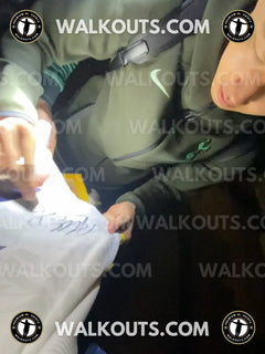 Son Heung-Min holding a piece of paper with 'WALKOUTS.COM' branding.
