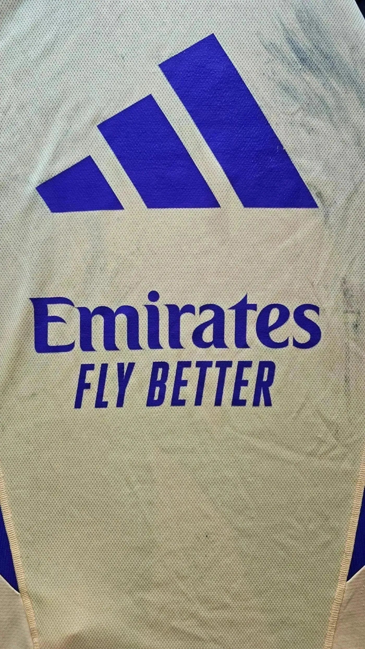 Detail view of the Real Madrid shirt showing the Emirates Fly Better sponsor and adidas logo.