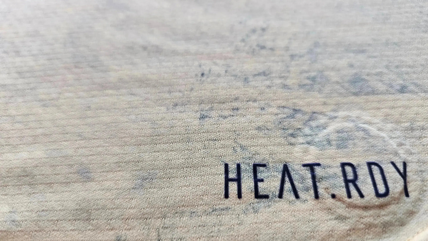 Detail showing the HEAT.RDY text on the fabric of the signed Thibaut Courtois football shirt.
