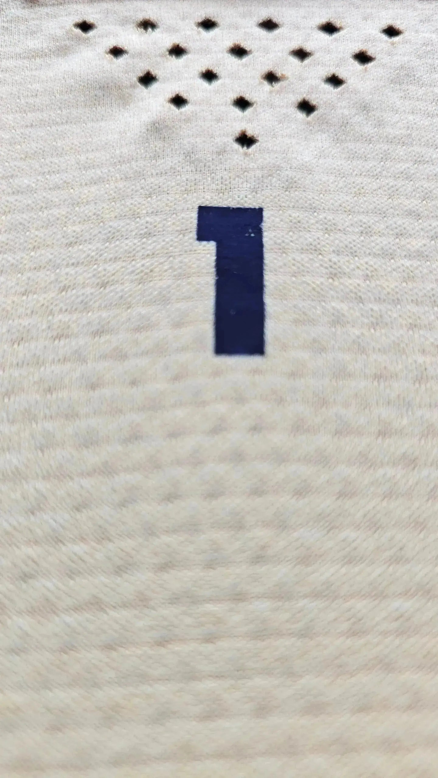 Close-up view showing the No. 1 on the back of the signed Real Madrid football shirt.