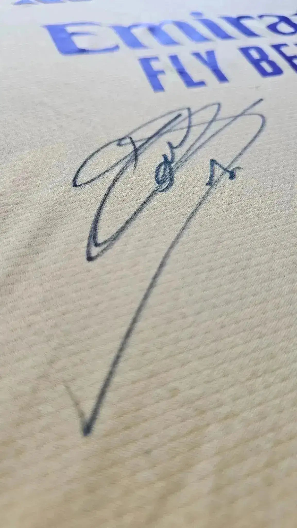 Detail showing the signature of Thibaut Courtois on a Real Madrid football shirt.