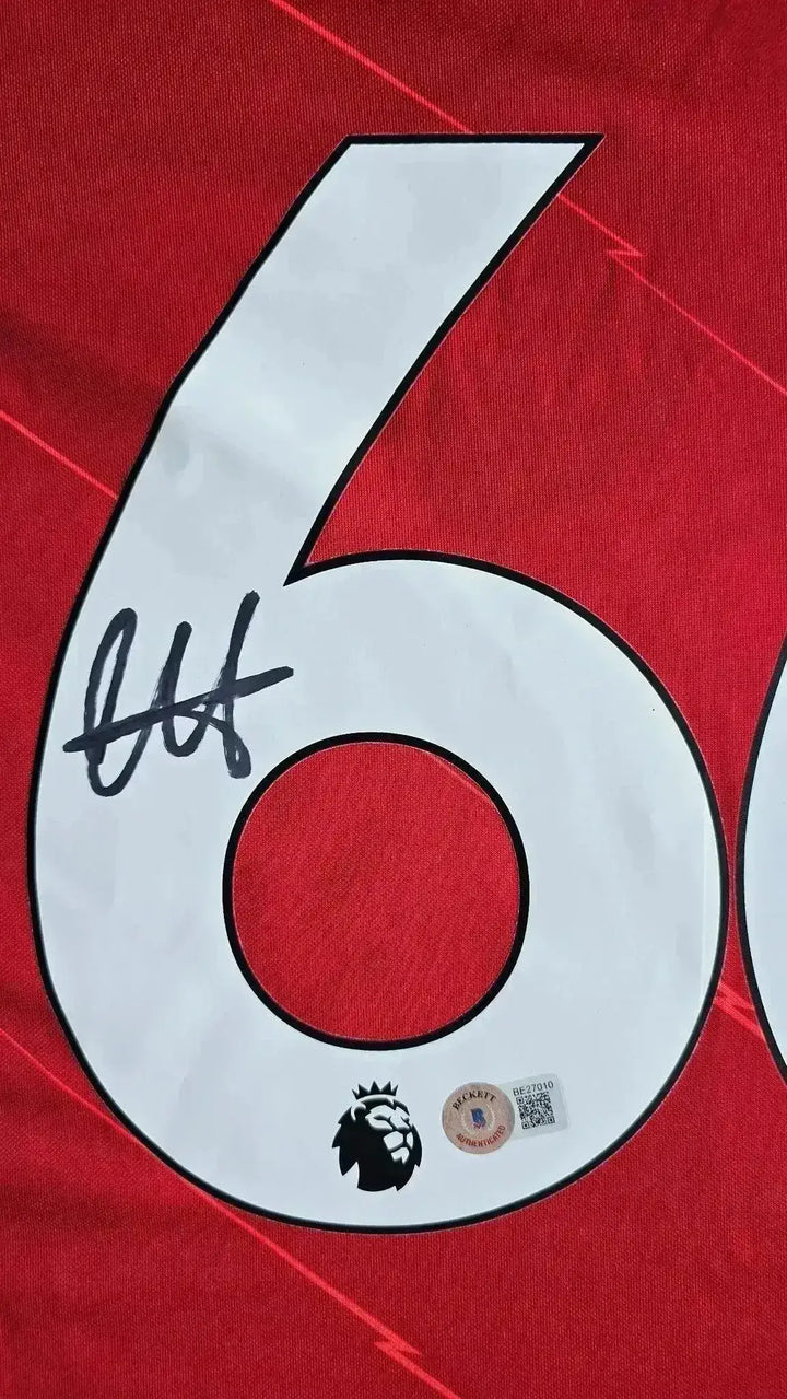 Close-up showing No. 66 with a black signature and Premier League lion emblem.