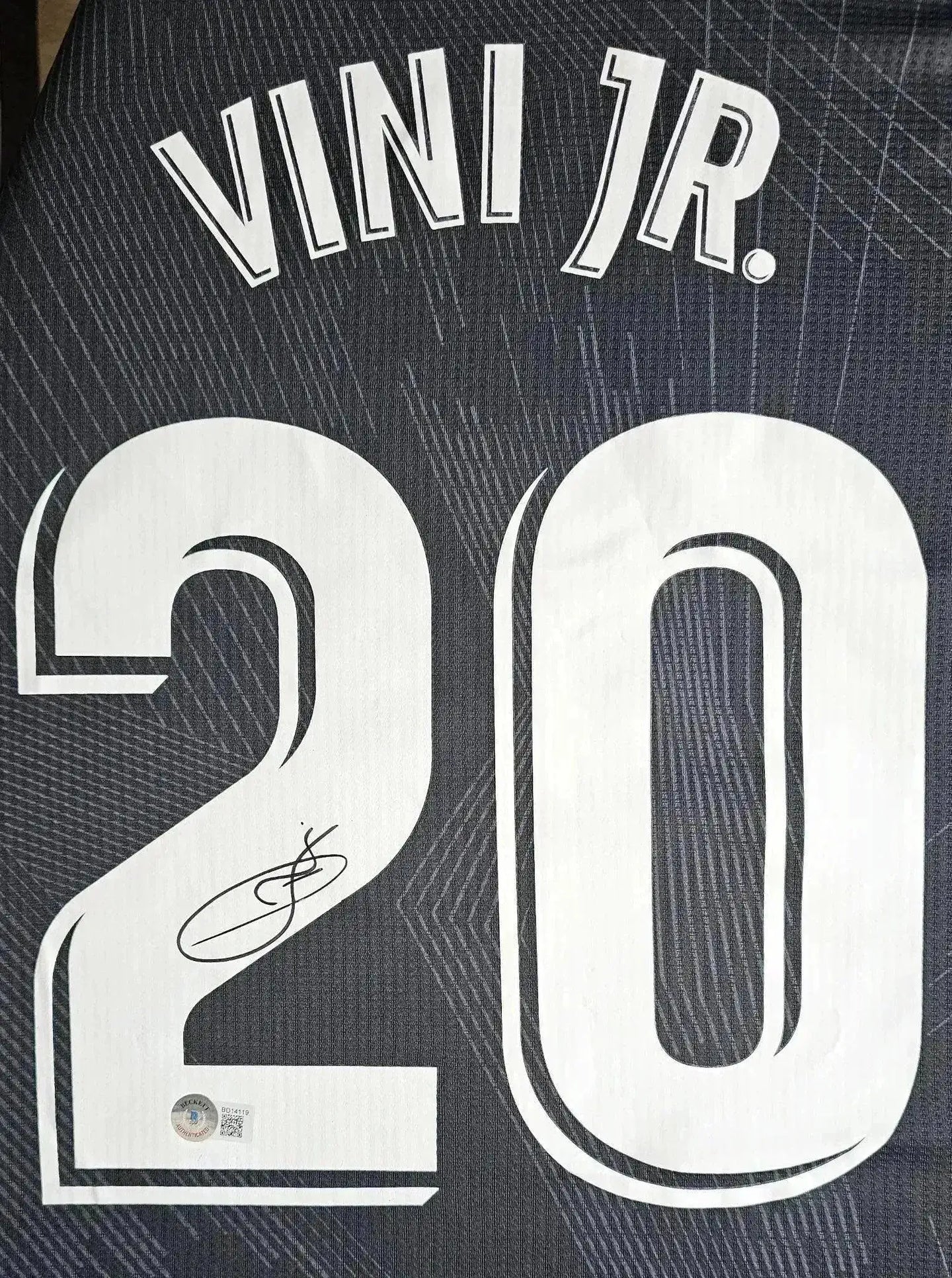 Back view featuring No. 20, VINI JR., and signature.