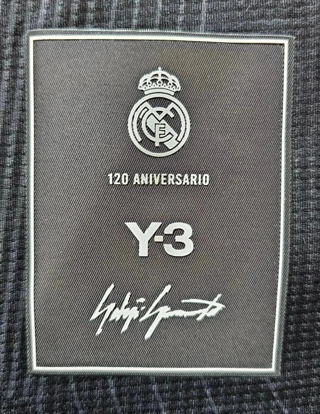 Crest detail showing Real Madrid logo, 120 Aniversario text, Y-3 branding, and signature.