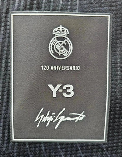 Crest detail showing Real Madrid logo, 120 Aniversario text, Y-3 branding, and signature.