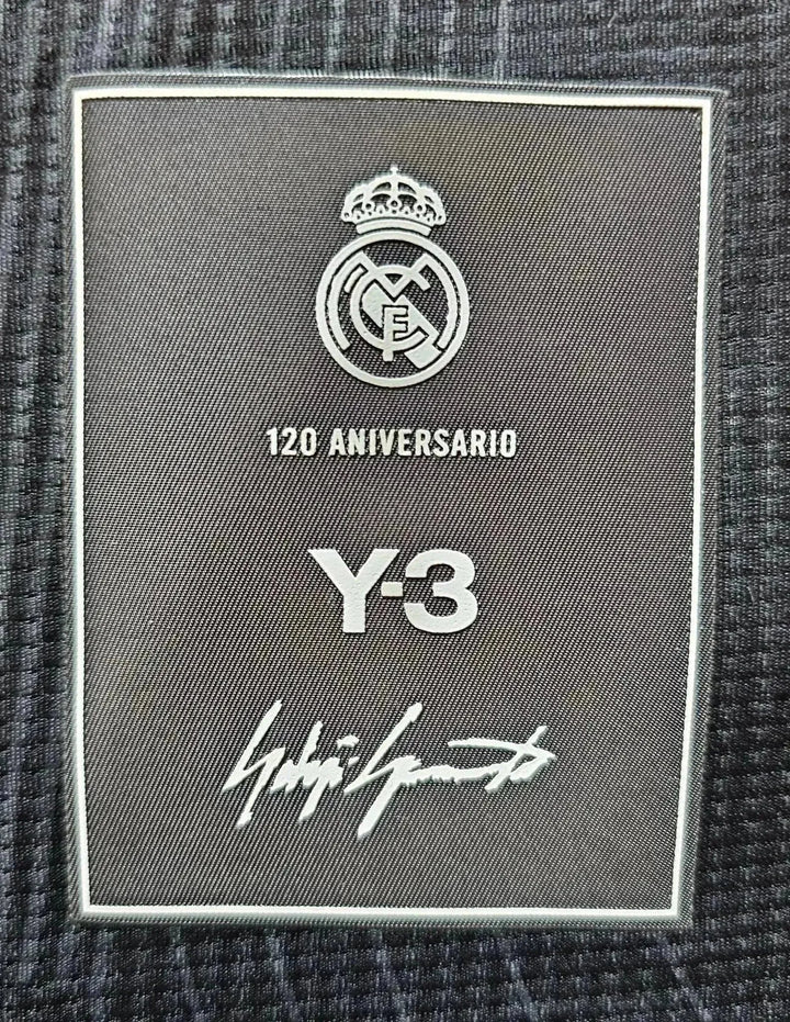 Crest detail showing Real Madrid logo, 120 Aniversario text, Y-3 branding, and signature.