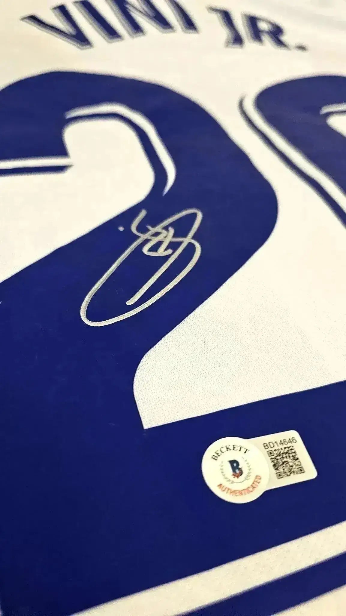 Close-up of the No. 20 on the signed soccer jersey with Vinícius Jr.'s signature and Beckett authentication label.