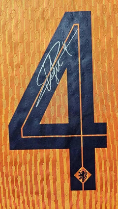 Detail view showing No. 4 and signature on orange football shirt.