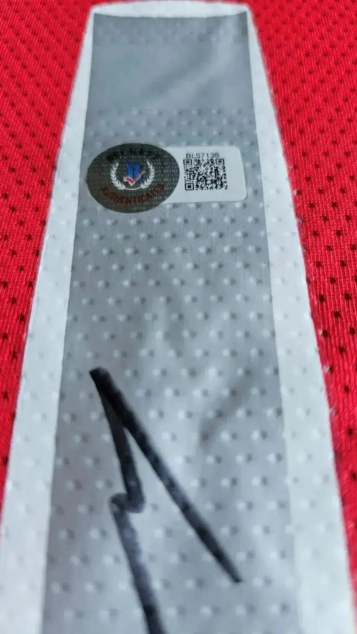 Detail showing the Beckett COA label and signature on Wayne Rooney signed soccer jersey.