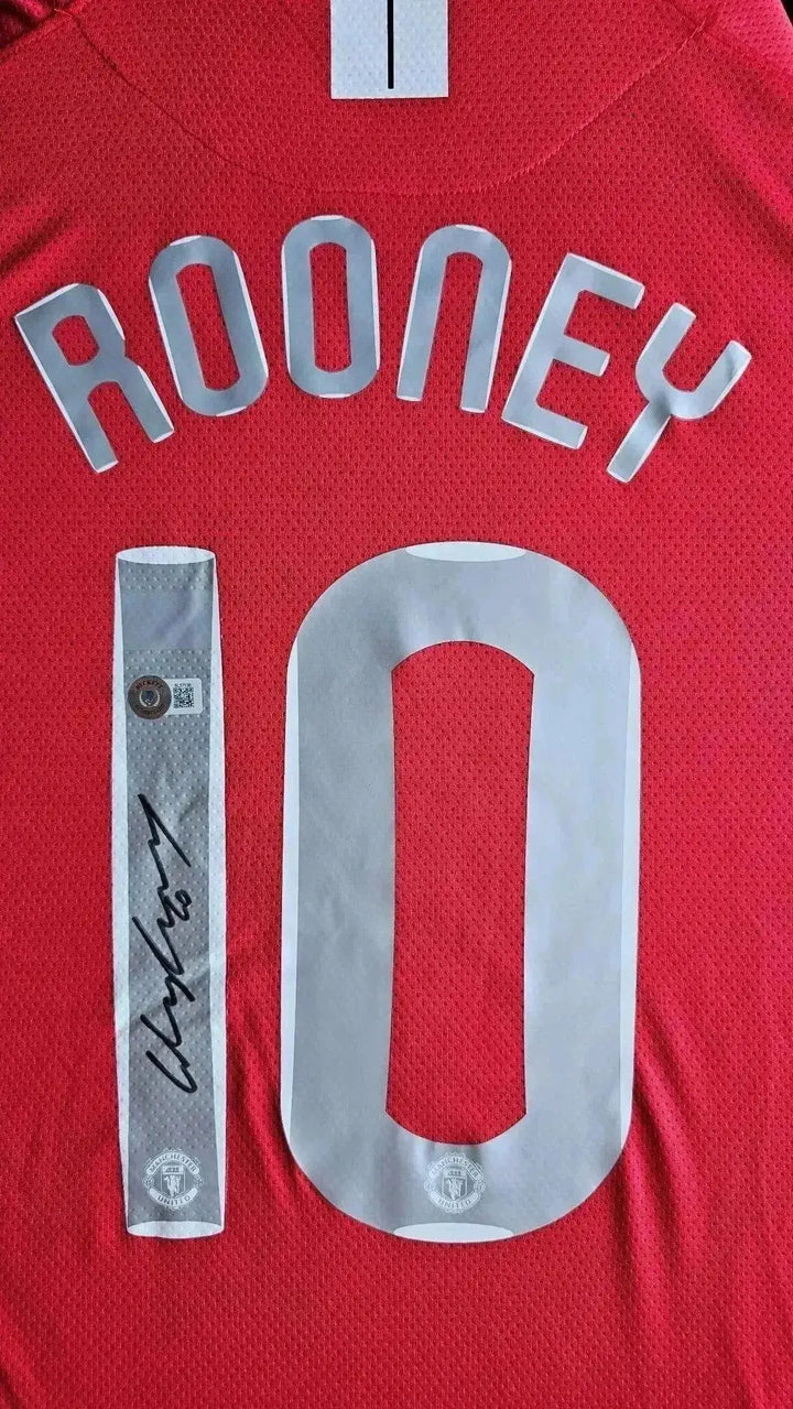 Detail view showing 'ROONEY' and No. 10 along with a visible signature on a red football shirt.