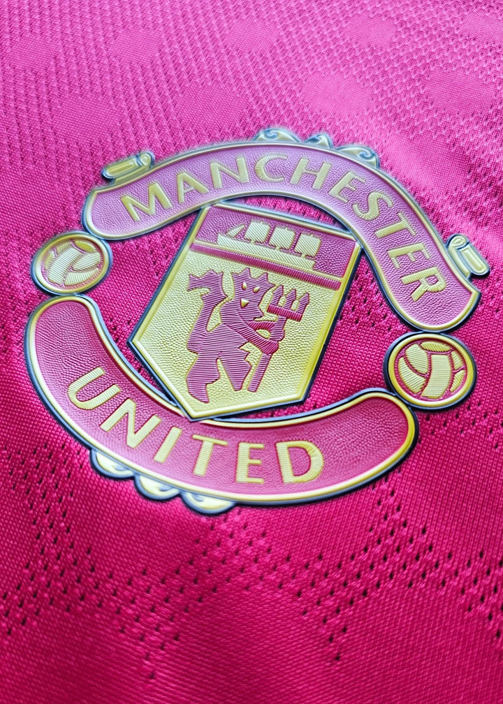 Crest detail of Manchester United showing the lion badge and text 'MANCHESTER UNITED'.