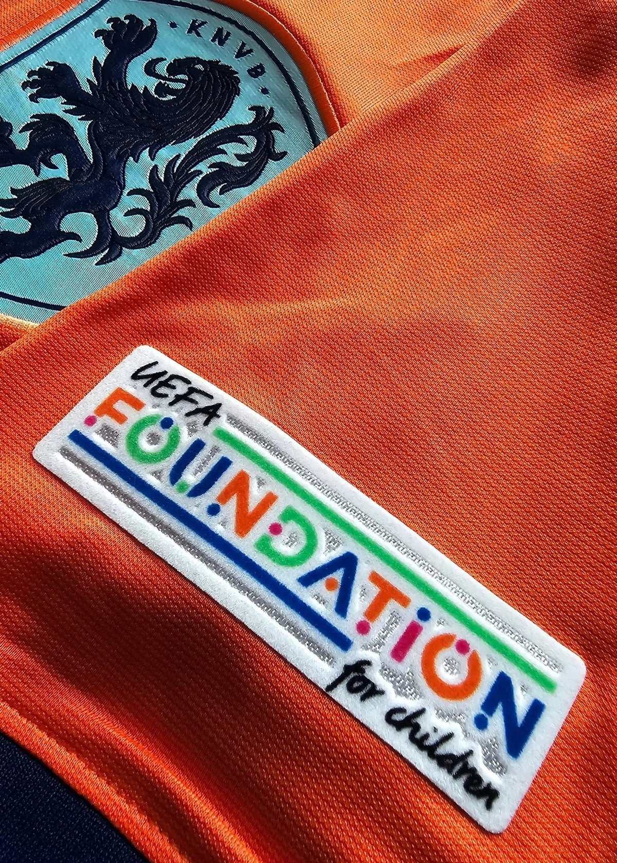 The pale blue KNVB Netherlands crest and a white 'UEFA Foundation for children' patch on the chest of Brian Brobbey's orange Holland shirt, No. 19.