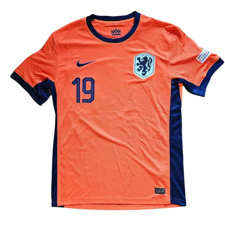 Front of an orange Netherlands home shirt with navy trim, Nike swoosh, KNVB lion crest, and printed number 19; Brian Brobbey, Holland Euro 2024.