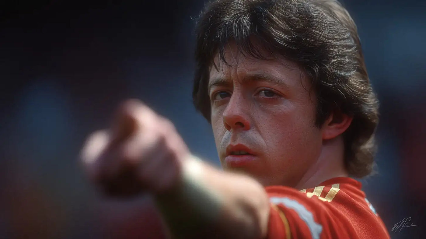 Brian Flynn in a red Wrexham football shirt pointing ahead, close-up portrait with the background softly blurred.