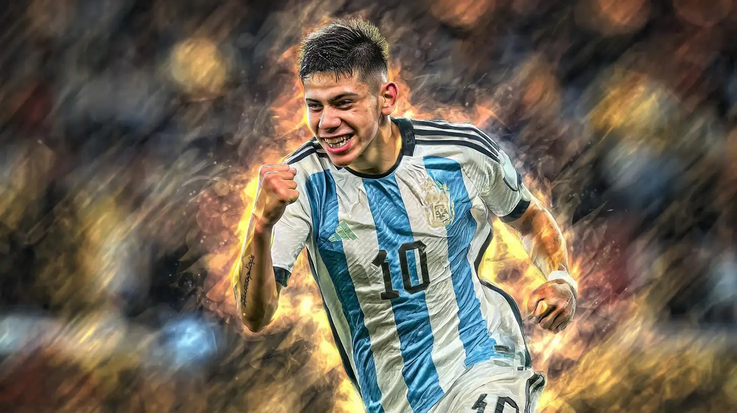 Claudio Echeverri celebrates with a clenched fist in Argentina’s sky-blue and white number 10 football shirt, smiling under bright stadium lights with motion blur behind.