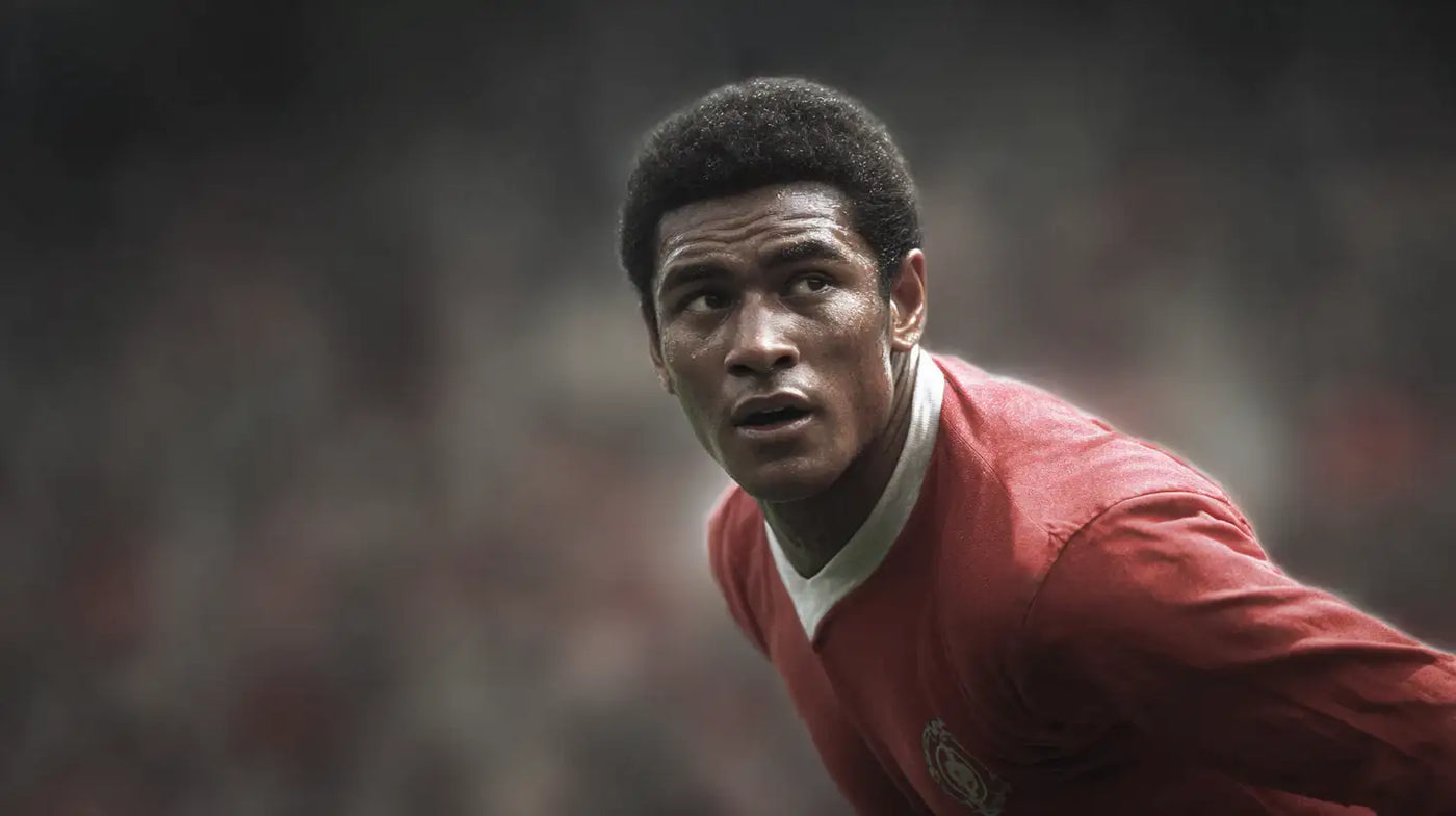 Eusébio wearing a red Benfica football shirt, classic portrait style with soft crowd background and vintage feel.