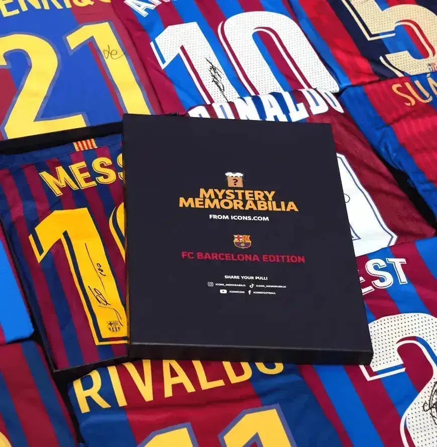 Detail view of signed Barcelona soccer jerseys, featuring names like Messi, Rivaldo, and more.
