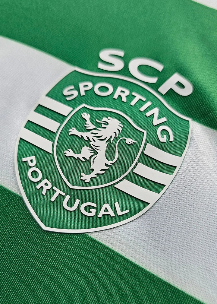 Close-up of a green and white striped Sporting Portugal jersey with the club crest and 'SCP' lettering.