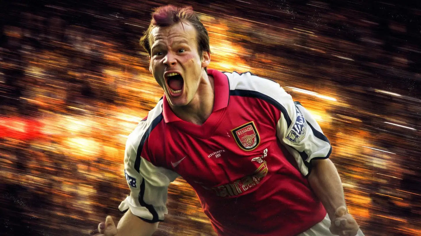 Freddie Ljungberg celebrating in red Arsenal home football shirt with white sleeves, shouting with arms outstretched during a match.