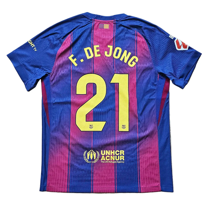 A blue and magenta striped FC Barcelona soccer jersey with 'F. DE JONG' and the number '21' printed on the back.