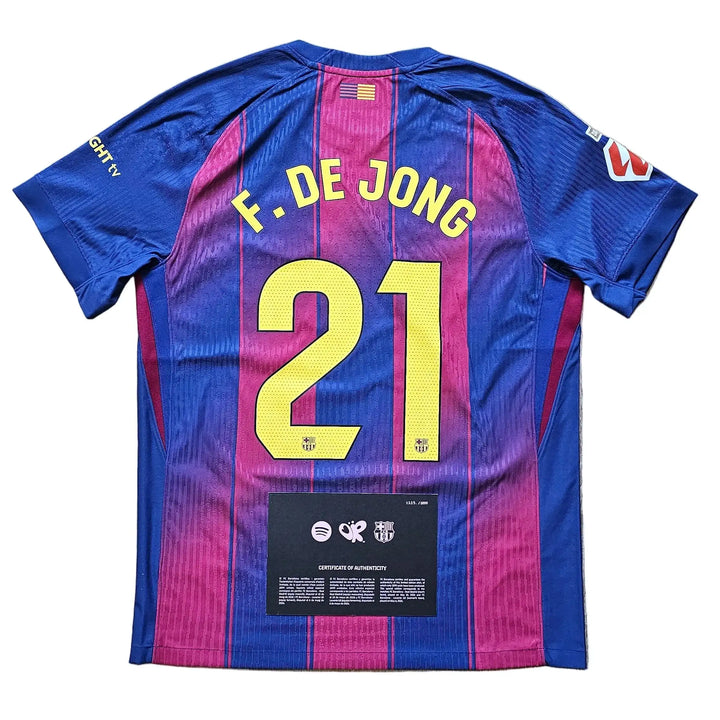 A FC Barcelona home jersey with 'F. DE JONG' and number '21' on the back.