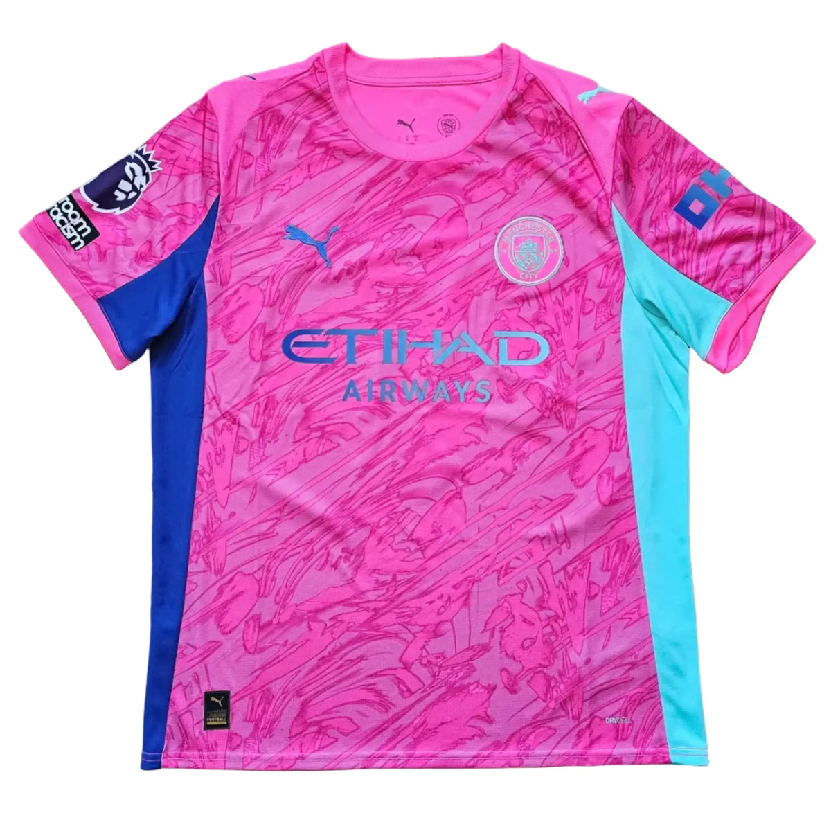 Front of a pink Manchester City 2025-26 shirt with the Etihad Airways sponsor, the club crest, a Puma logo, and teal and blue side panels.