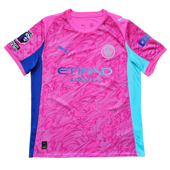 Front of a pink Manchester City 2025-26 shirt with the Etihad Airways sponsor, the club crest, a Puma logo, and teal and blue side panels.