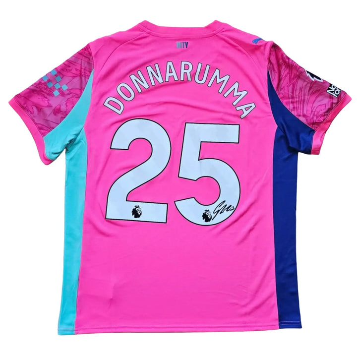Back of a pink Manchester City shirt with 'DONNARUMMA' and No. 25 in white, a black signature beneath, and a Premier League badge.