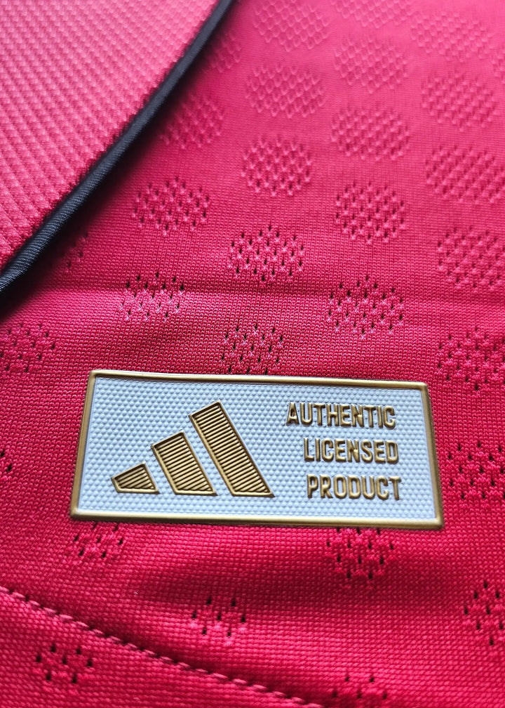 Adidas brand tag reading Authentic Licensed Product in gold, sewn inside the Jack Fletcher Manchester United F.C. 2025-2026 signed shirt.