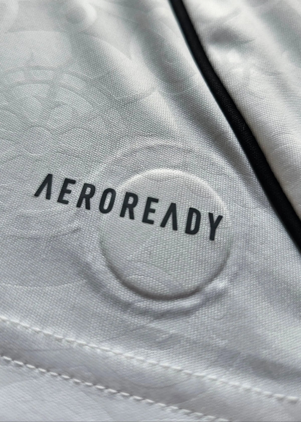 Close-up of the AEROREADY fabric print and black piping inside the collar, Josh King's Fulham F.C. 2025-2026 shirt.