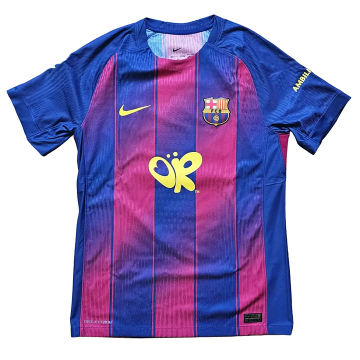 A Nike FC Barcelona home soccer jersey with blue and magenta vertical stripes, laid flat on a light wood floor. The jersey features the yellow 'Jupiler' sponsor logo on the center chest, a yellow Nike swoosh on the right chest, and the FC Barcelona crest on the left chest.