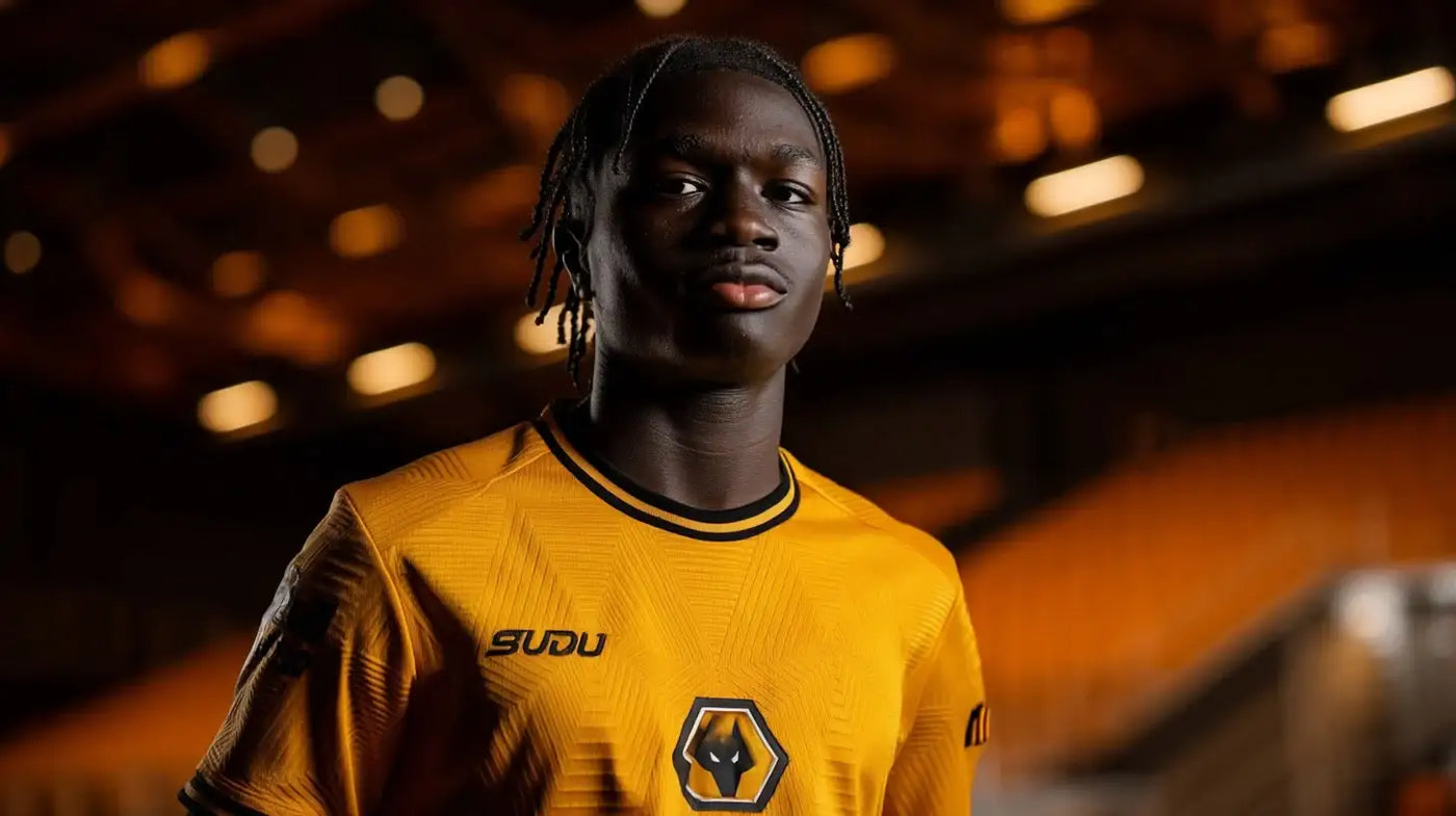 Mateus Mane wearing Wolverhampton Wanderers (Wolves) gold shirt, portrait in the stands looking to the side.